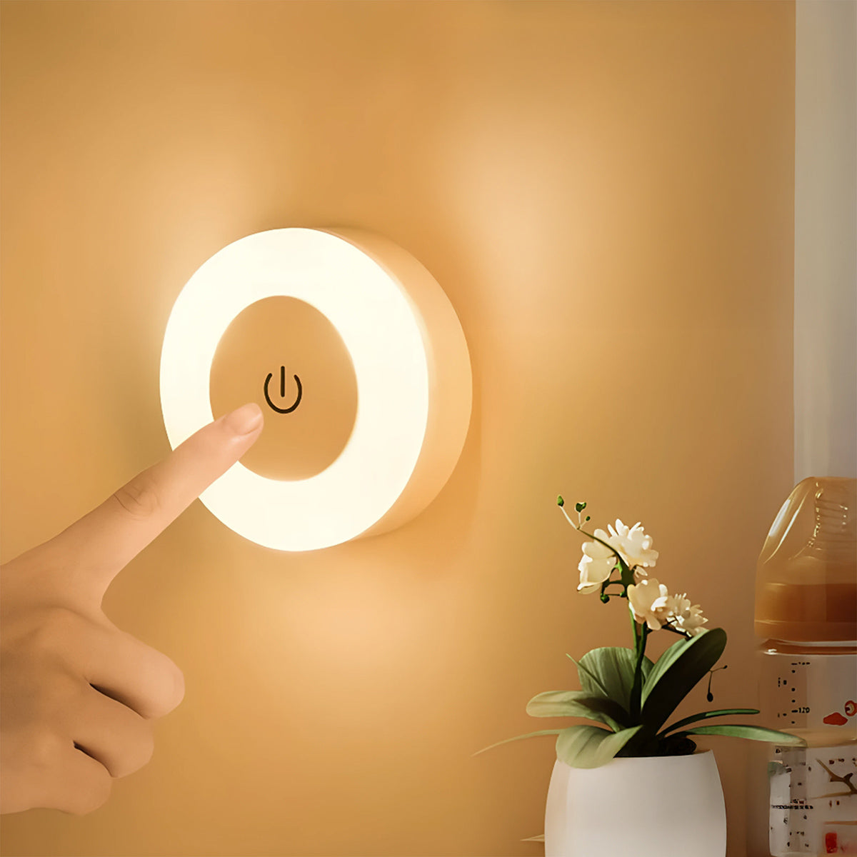 Detalle de un dedo tocando la superficie de la lampara encendida con luz calida demostrando su sensor táctil de alta sensibilidad